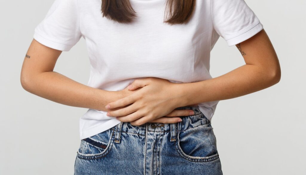 Mulher com desconforto abdominal (Crédito: benzoix/freepik)
